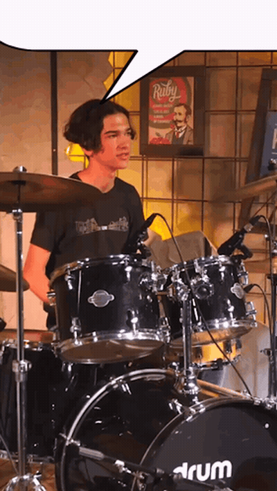 Man in Blue Shirt With Heart Playing Drums