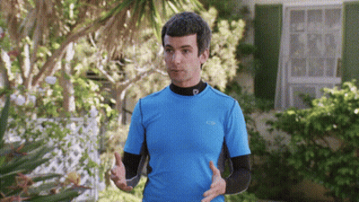 Man In Blue Shirt With Letter P Standing In Front Of House GIF