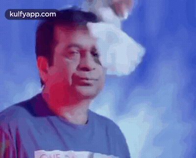 Man In Blue Shirt With Paper On Head GIF
