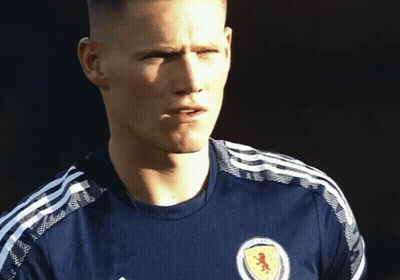 Man In Blue Shirt With Red Lion GIF
