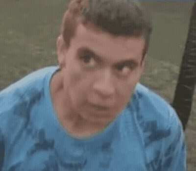 Man In Blue Shirt With Serious Look GIF