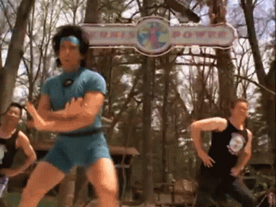 Man In Blue Shorts Dancing Near This Power Sign GIF