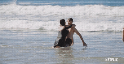 Man In Blue Shorts Standing In Ocean GIF