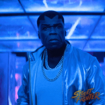 Man In Blue Street Fighter Jacket Dark Room GIF