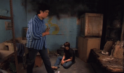 Man In Blue Striped Shirt Standing Next To Boy Sitting On Floor GIF