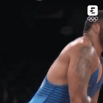 Man In Blue Striped Shirt Wrestling Another Man GIF