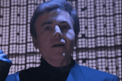 Man In Blue Suit And Black Turtleneck Standing GIF