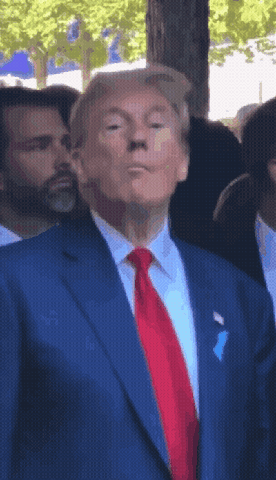 Man In Blue Suit And Red Tie In Crowd GIF
