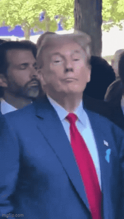 Man In Blue Suit And Red Tie Making Funny Face GIF