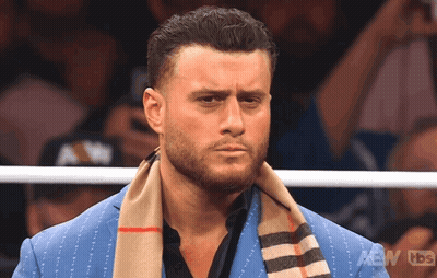 Man In Blue Suit And Scarf In AEW TBS Ring GIF