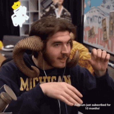 Man In Blue Suit And Tie In Front Of MTV Logo GIF