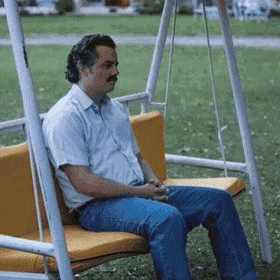 Man In Blue Suit And Tie Sitting In Front Of Postgame Live Sign GIF