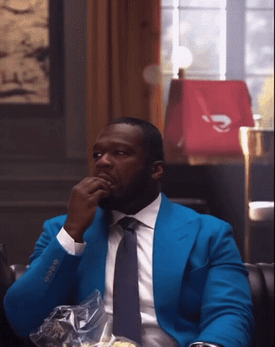 Man In Blue Suit And Tie Sitting GIF