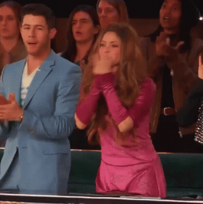 Man In Blue Suit And Woman In Pink Dress Applauding GIF