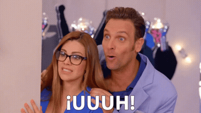Man In Blue Suit And Woman With Glasses Standing Together GIF