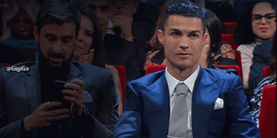 Man In Blue Suit Checking Phone At Theater GIF