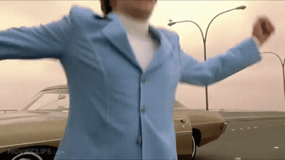 Man In Blue Suit Dancing In Front Of Car GIF