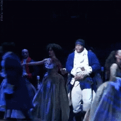 Man In Blue Suit Dancing On Stage With Group GIF