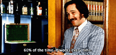 Man In Blue Suit Holding Beer At Desk GIF
