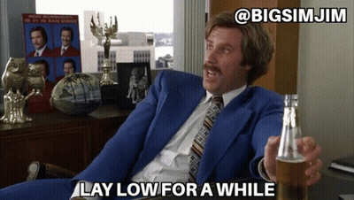 Man In Blue Suit Holding Beer Saying Lay Low GIF