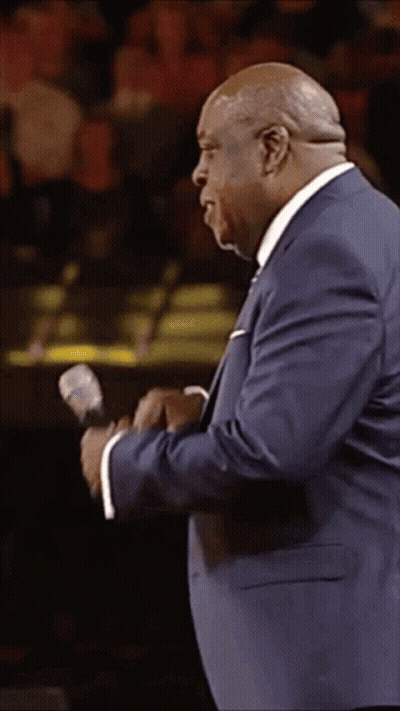 Man In Blue Suit Holding Microphone GIF