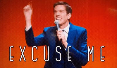 Man In Blue Suit Holding Microphone With Excuse Me GIF