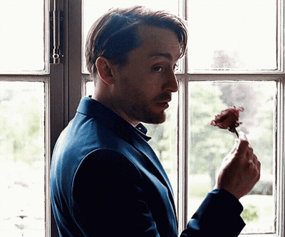 Man In Blue Suit Holding Rose GIF