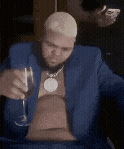 Man In Blue Suit Holding Wine Glass GIF