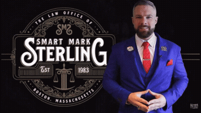 Man In Blue Suit In Front Of Smart Mark Sterling Logo GIF