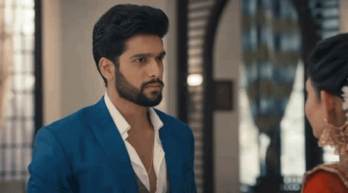 Man In Blue Suit Looks At Woman In Red Dress GIF