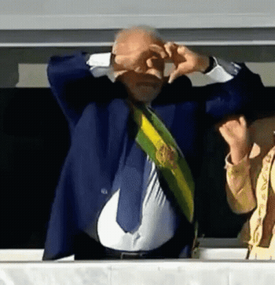 Man In Blue Suit Making Heart With Hands GIF