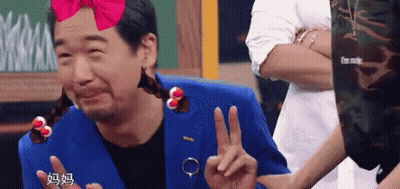 Man In Blue Suit Making Peace Sign GIF