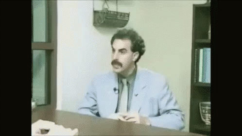 Man in Blue Suit Sitting at Desk