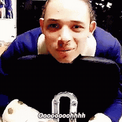 Man In Blue Suit Sitting Holding Purse Saying Oooooohhh GIF