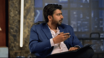 Man In Blue Suit Sitting In Chair GIF
