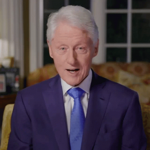 Man In Blue Suit Sitting On Couch GIF