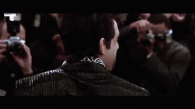 Man In Blue Suit Standing In Crowd GIF