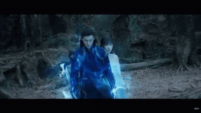 Man In Blue Suit Standing With Woman In Forest GIF