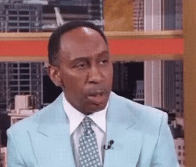 Man In Blue Suit Talking Into Microphone GIF