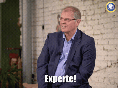 Man in Blue Suit With Experte Text