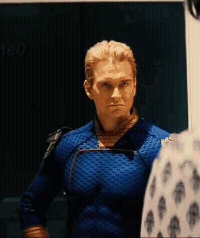 Man In Blue Superhero Costume Standing Next To Man In White Shirt GIF