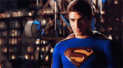 Man In Blue Superman Costume In Front Of Building GIF