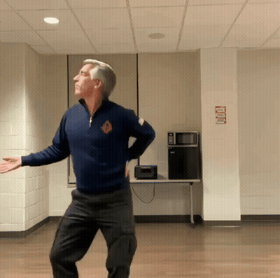 Man In Blue Sweater Dancing With No Smoking Sign GIF