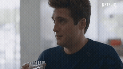 Man In Blue Sweater Holding Glass Of Water GIF