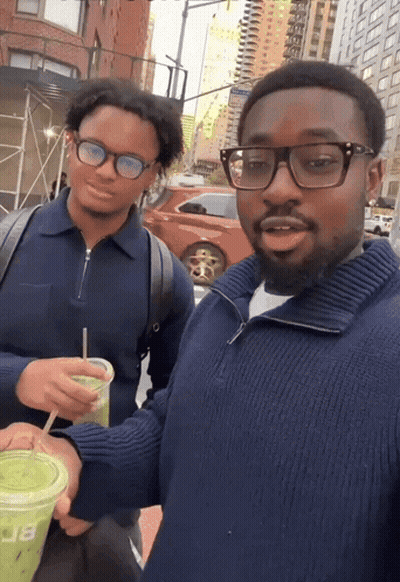 Man In Blue Sweater Holding Green Cup With Letter B GIF