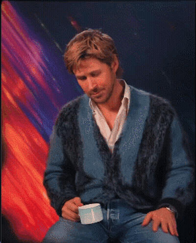 Man In Blue Sweater Holding White Cup GIF