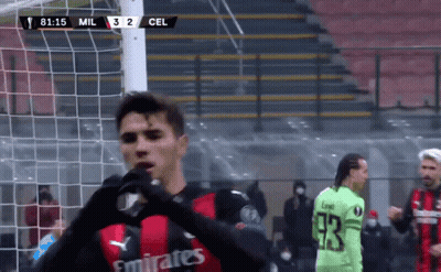 Man In Blue Sweater In Front Of Madrid Wall GIF