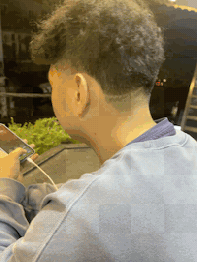 Man In Blue Sweater Looking At Phone GIF