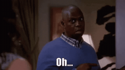 Man In Blue Sweater Pointing At Woman GIF