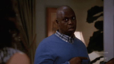 Man In Blue Sweater Pointing To Oh GIF